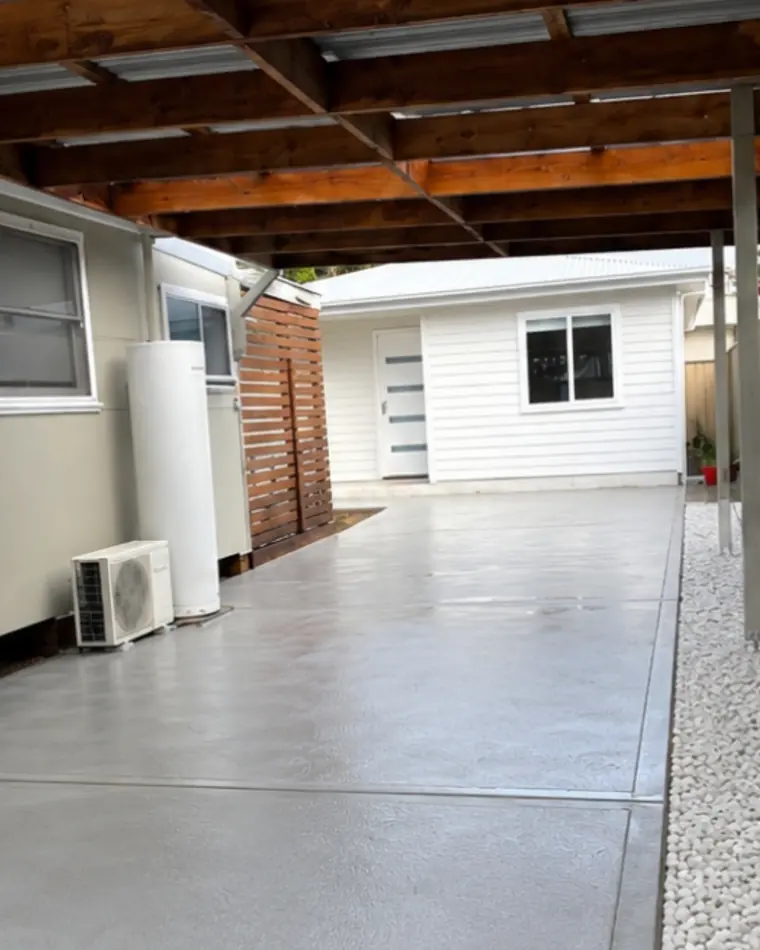Fresh concrete slab poured under a carport
